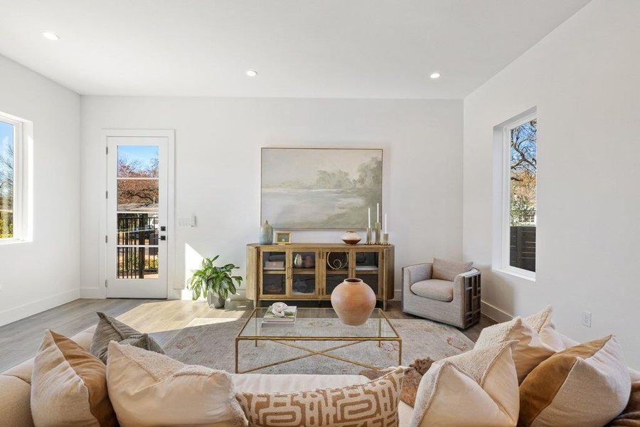 Living room with recessed lighting and wood finished floors
