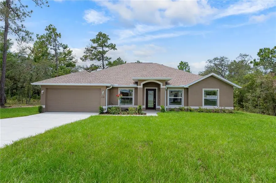 Front exterior of a new home in , Weeki Wachee, FL, highlighting curb appeal (Image 2). Front exterior of a new home in , Weeki Wachee, FL, highlighting curb appeal (Image 2).