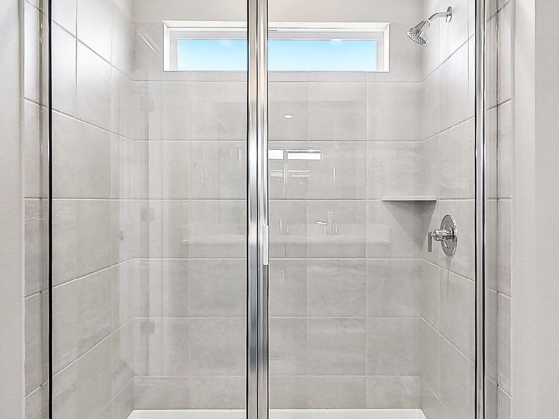 Live in luxury in this primary bathroom with a walk-in shower.