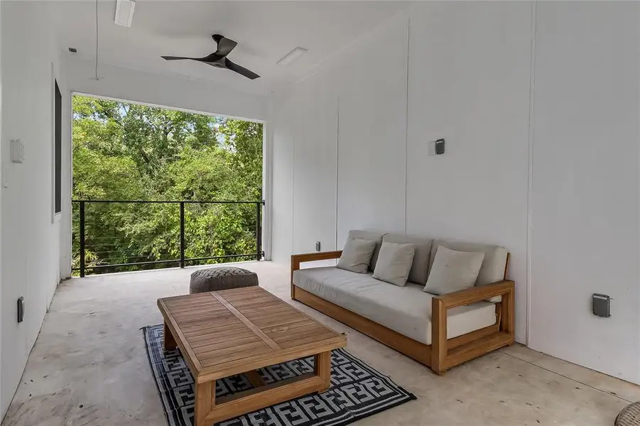 An inviting open-air balcony offers treetop views, perfect for relaxation and enjoying the outdoors.