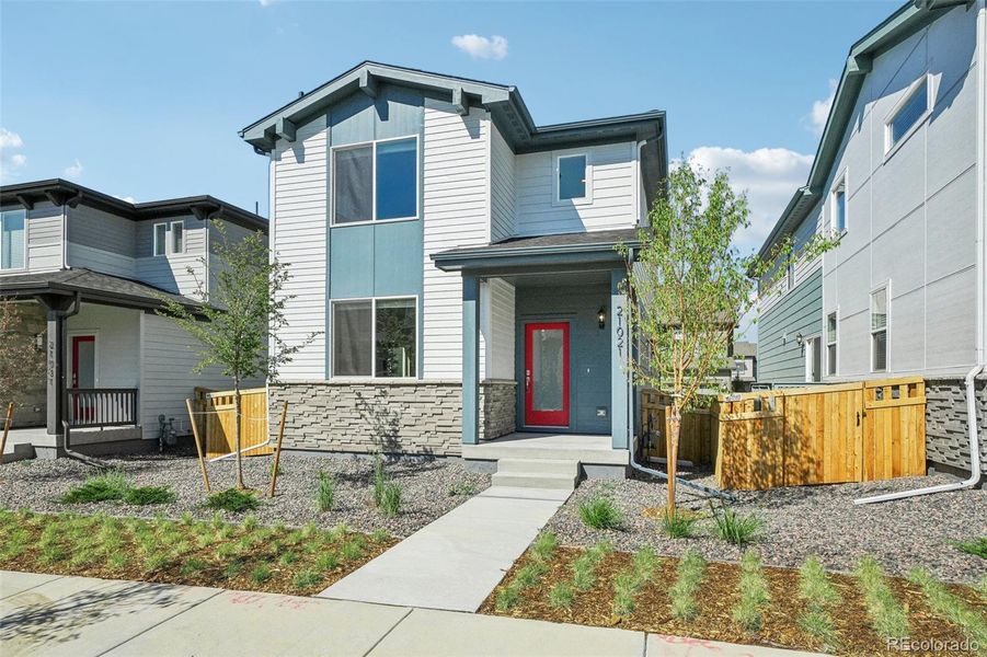 Front exterior of a new home in Woodrose at Painted Prairie, Aurora, CO, highlighting curb appeal (Image 23).