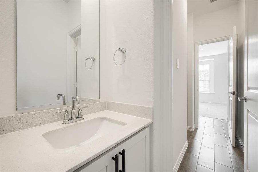 Bathroom featuring vanity and dark tile patterned flooring Bathroom featuring vanity and dark tile patterned flooring