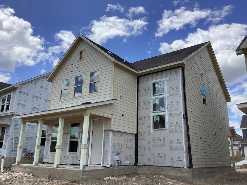 Front exterior of a new home in The Cottages at Lariat, Liberty Hill, TX, highlighting curb appeal (Image 15). Front exterior of a new home in The Cottages at Lariat, Liberty Hill, TX, highlighting curb appeal (Image 15).