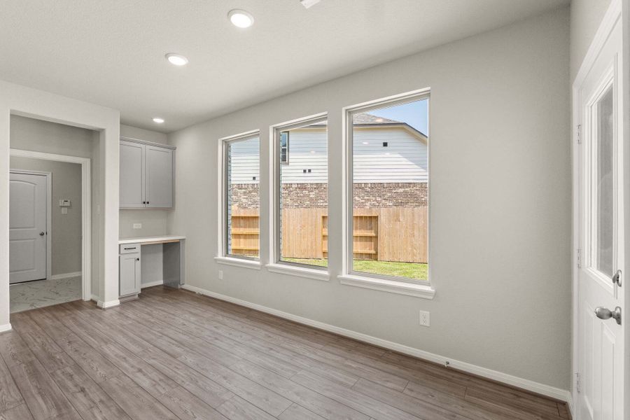 The dining room is light and bright and features a built in desk