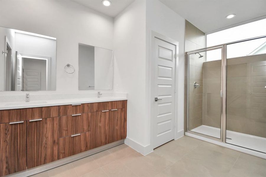 Primary Bedroom Bathroom with Oversized Walk-in Shower with Window and Quartz Countertops