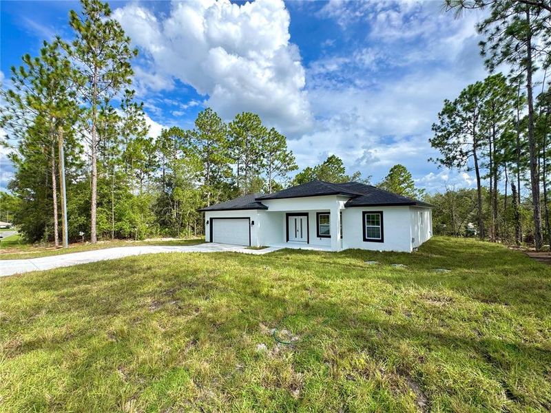 Front exterior of a new home in , Citrus Springs, FL, highlighting curb appeal (Image 16).