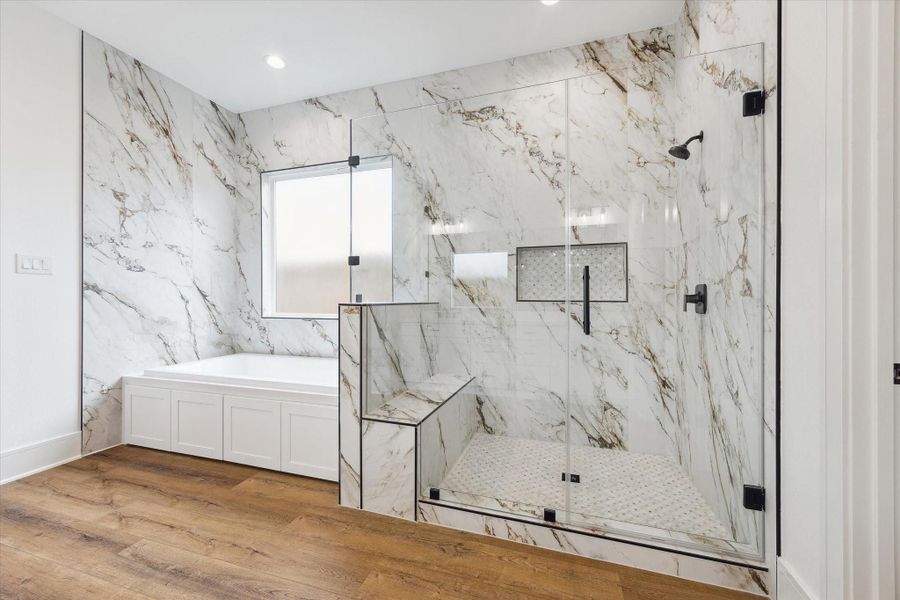Experience a stunning primary bathroom that truly wows, complete with an expansive walk-in shower featuring a comfortable seat and a luxurious six-foot soaker tub for ultimate relaxation. Experience a stunning primary bathroom that truly wows, complete with an expansive walk-in shower featuring a comfortable seat and a luxurious six-foot soaker tub for ultimate relaxation.