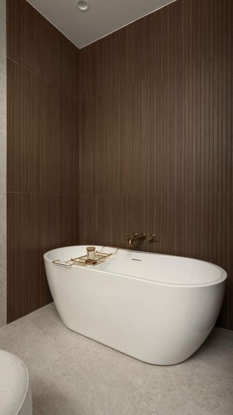 Indulge in relaxation with this elegant freestanding tub set against a backdrop of rich, textured wall tiling. Indulge in relaxation with this elegant freestanding tub set against a backdrop of rich, textured wall tiling.