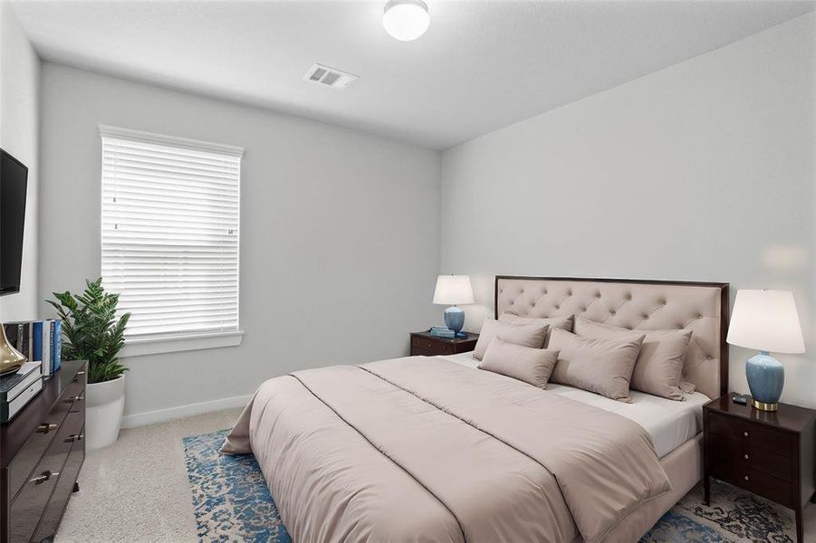 Secondary bedroom features plush carpet, neutral paint and a large window with privacy blinds.