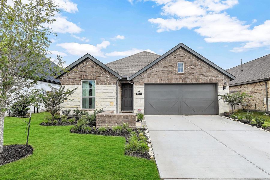 Front exterior of a new home in Bridgeland Creekland Village, Cypress, TX, highlighting curb appeal (Image 2). Front exterior of a new home in Bridgeland Creekland Village, Cypress, TX, highlighting curb appeal (Image 2).
