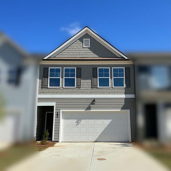 Front exterior of a new home in Rivershire Place, Villa Rica, GA, highlighting curb appeal (Image 1). Front exterior of a new home in Rivershire Place, Villa Rica, GA, highlighting curb appeal (Image 1).