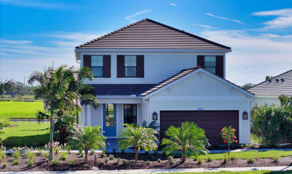 Front exterior of a new home in Palm Grove, Lakewood Ranch, FL, highlighting curb appeal (Image 2).