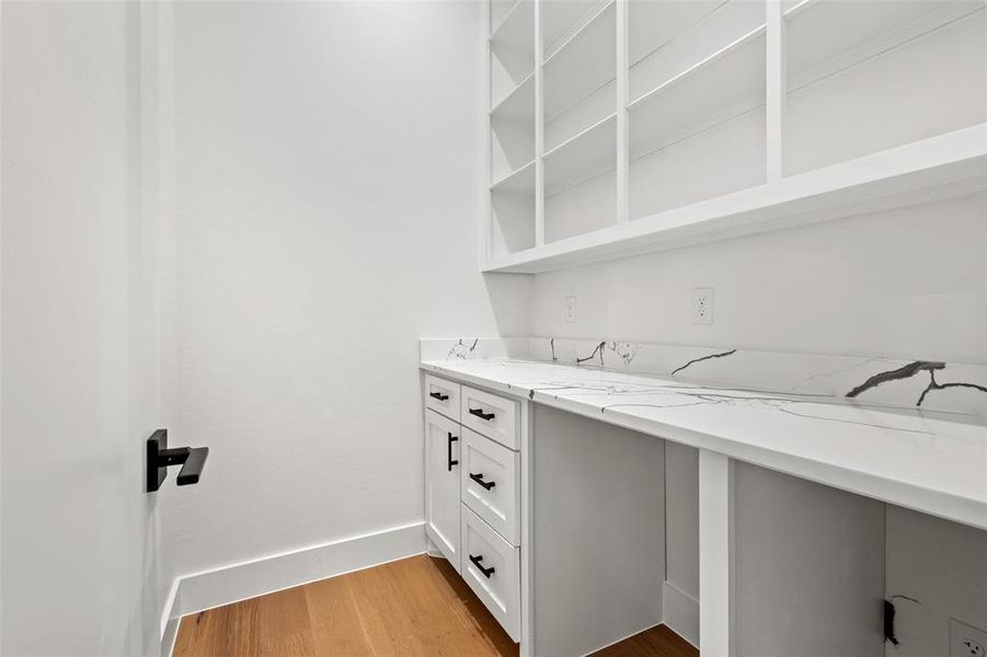 Unfurnished office with light wood-style floors and baseboards Unfurnished office with light wood-style floors and baseboards