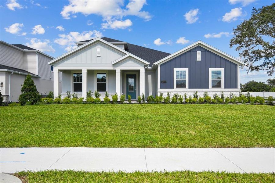 Front exterior of a new home in Solace at Corner Lake, Orlando, FL, highlighting curb appeal (Image 1).