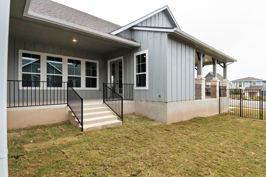 Property entrance featuring board and batten siding and a shingled roof