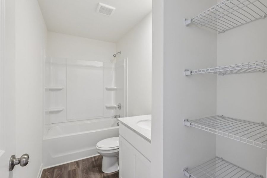 A bathroom with a tub toilet and sink.