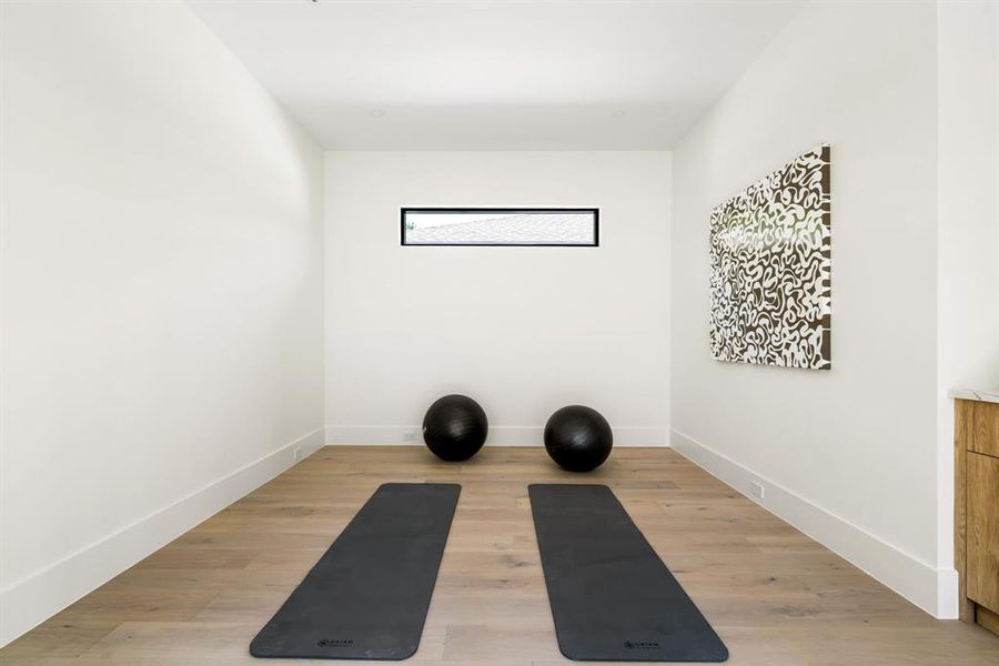 Workout area featuring light wood finished floors Workout area featuring light wood finished floors