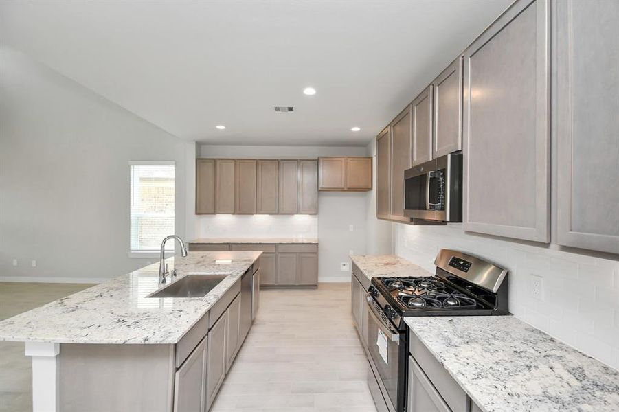 This generously spacious kitchen is a dream realized! Sample photo of completed home with similar floor plan. As-built interior colors and selections may vary.