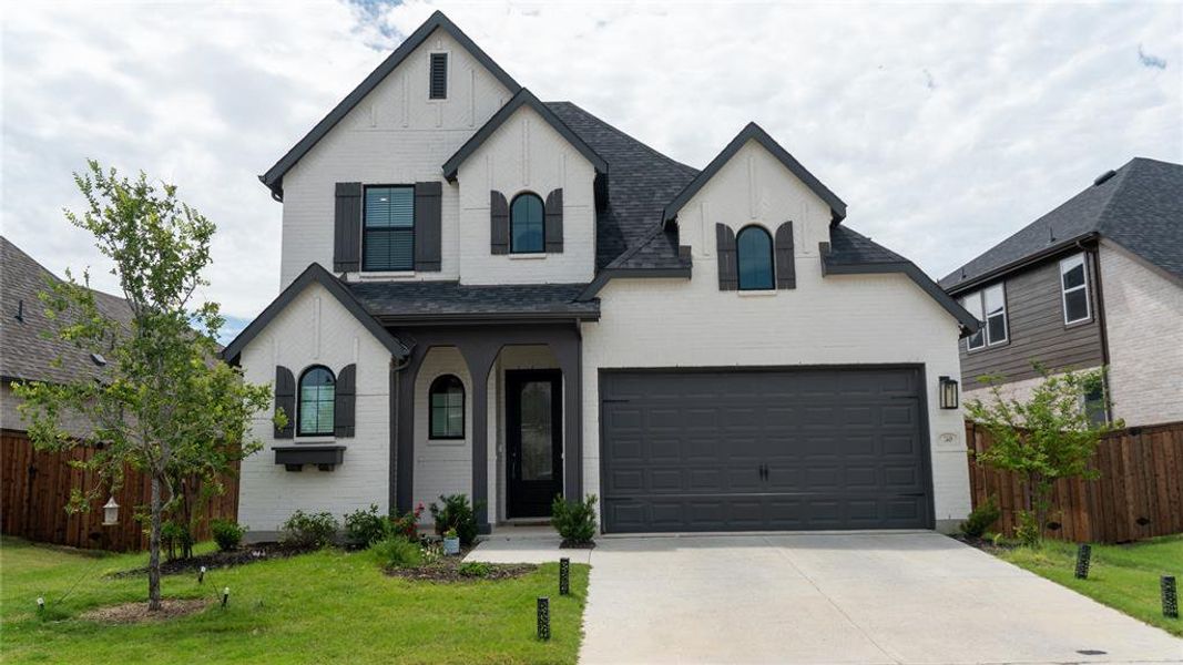 Front exterior of a new home in Sandbrock Ranch, Aubrey, TX, highlighting curb appeal (Image 26). Front exterior of a new home in Sandbrock Ranch, Aubrey, TX, highlighting curb appeal (Image 26).