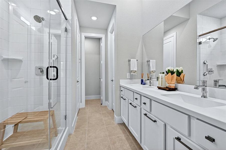 Full bath featuring double vanity, a shower stall, tile patterned floors, and recessed lighting Full bath featuring double vanity, a shower stall, tile patterned floors, and recessed lighting