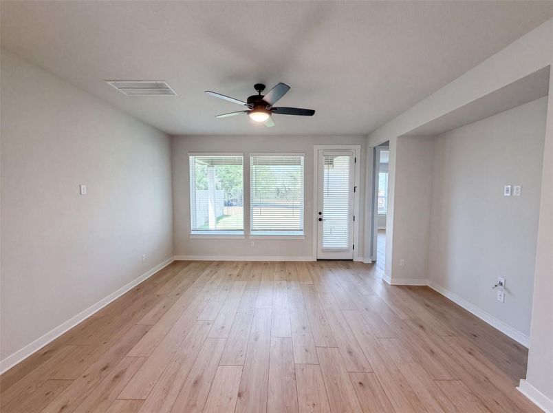 Sun-filled interior space with beautiful wood flooring and multiple windows framing the outdoor area. Sun-filled interior space with beautiful wood flooring and multiple windows framing the outdoor area.
