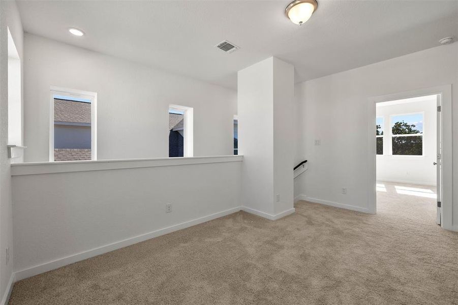 Empty room featuring carpet floors and baseboards Empty room featuring carpet floors and baseboards