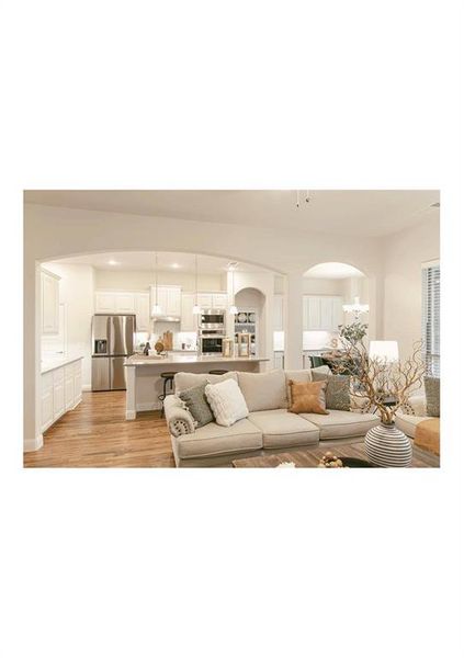 Living room featuring an inviting chandelier and light hardwood / wood-style flooring