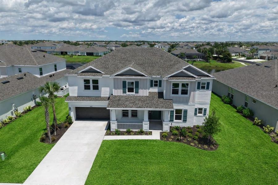 Front exterior of a new home in Park East at Azario, Bradenton, FL, highlighting curb appeal (Image 27). Front exterior of a new home in Park East at Azario, Bradenton, FL, highlighting curb appeal (Image 27).