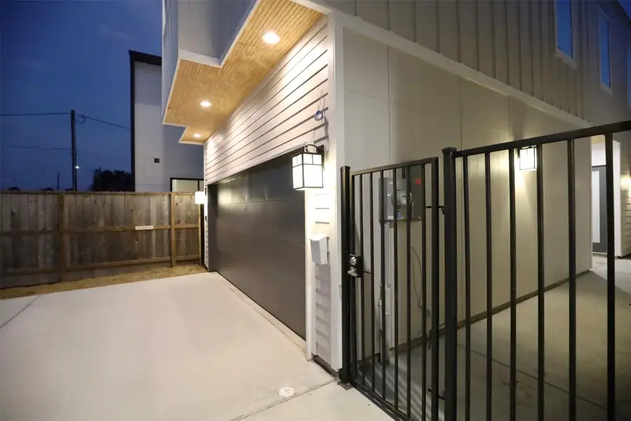 Wide metal gate at the entrance, with pre-wiring above for effortless security camera installation, providing convenience and entry visibility. Wide metal gate at the entrance, with pre-wiring above for effortless security camera installation, providing convenience and entry visibility.