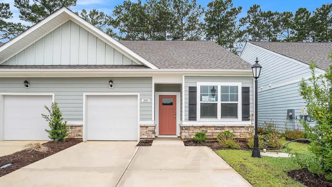 Exterior details and patio area of a home in Rich Square at Brunswick Plantation, Ash (Image 1).
