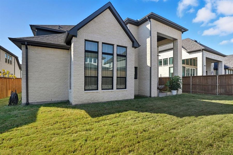 Rear view of house with brick siding and roof with shingles Rear view of house with brick siding and roof with shingles