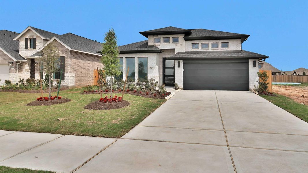 Front exterior of a new home in StoneCreek Estates, Richmond, TX, highlighting curb appeal (Image 2). Front exterior of a new home in StoneCreek Estates, Richmond, TX, highlighting curb appeal (Image 2).