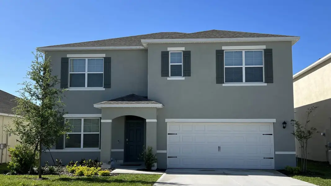 Front exterior of a new home in Crosswinds, Haines City, FL, highlighting curb appeal (Image 1). Front exterior of a new home in Crosswinds, Haines City, FL, highlighting curb appeal (Image 1).