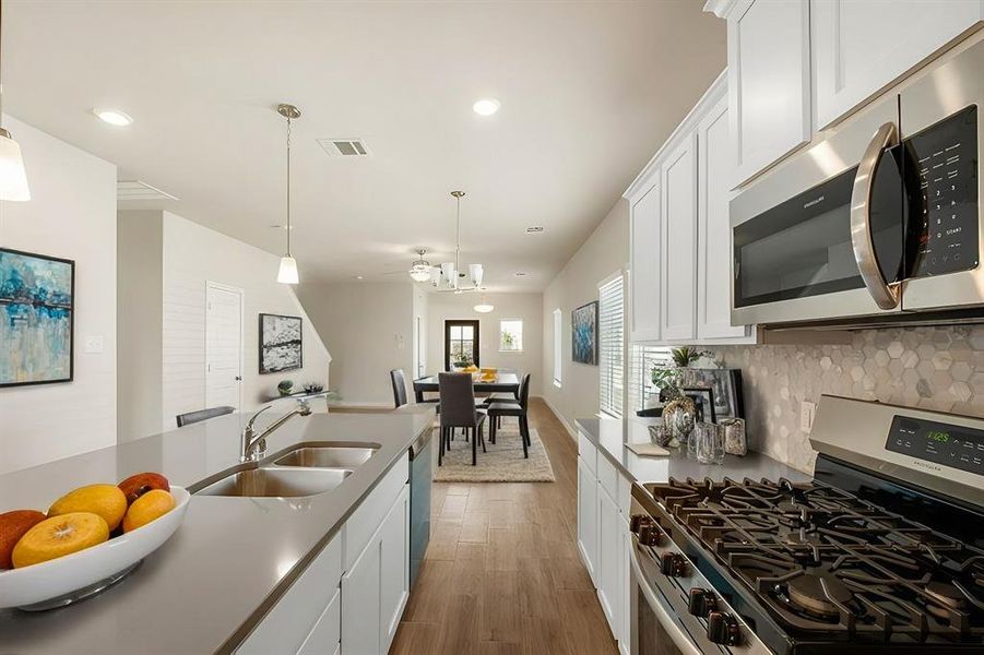 A chef’s dream kitchen! Featuring Silestone Quartz countertops, a walk-in pantry, and stainless steel appliances, this space is designed for both style and functionality. The open layout flows seamlessly into the living area.