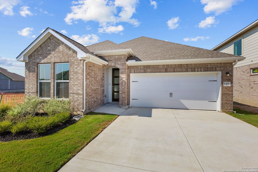 Front exterior of a new home in Sunflower Ridge, New Braunfels, TX, highlighting curb appeal (Image 16). Front exterior of a new home in Sunflower Ridge, New Braunfels, TX, highlighting curb appeal (Image 16).