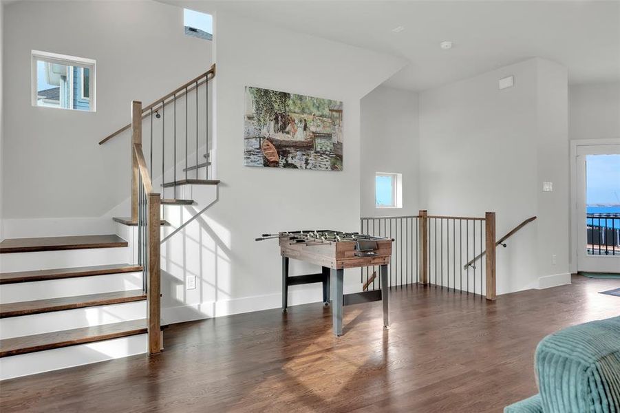 Staircase featuring a high ceiling and wood finished floors