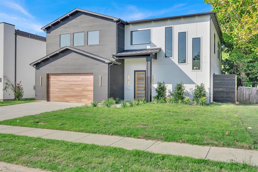 Contemporary house with a front yard and a garage