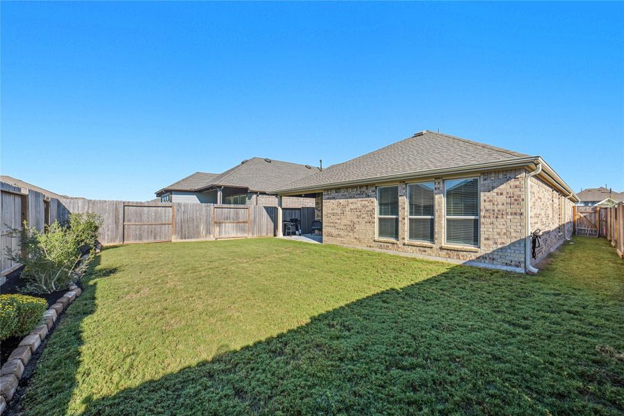 Spacious backyard featuring a well-maintained lawn enclosed with a wooden fence, providing privacy and a great area for outdoor activities! Spacious backyard featuring a well-maintained lawn enclosed with a wooden fence, providing privacy and a great area for outdoor activities!