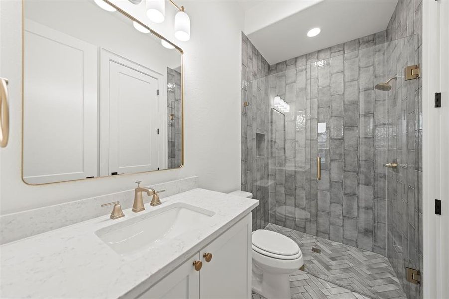 Full bathroom featuring vanity, a stall shower, and recessed lighting