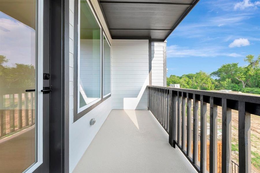 Balcony with wood railing, light-colored flooring, and exterior siding