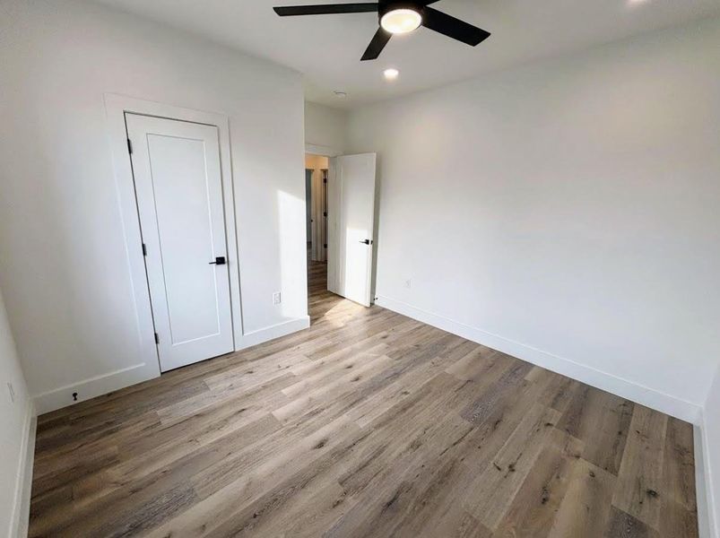 Unfurnished bedroom with light wood-style floors, recessed lighting, and a ceiling fan
