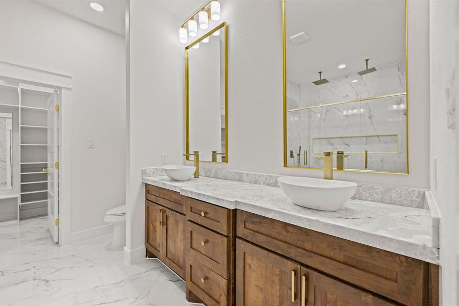 Dual vanity with wood-finish cabinetry, light-toned countertops, and vessel sinks