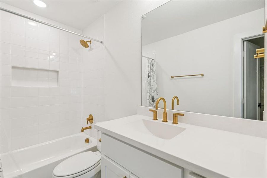 Full bathroom featuring vanity, shower / bath combo, and recessed lighting