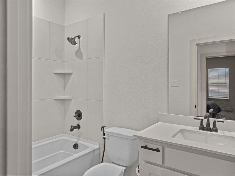 Full bathroom featuring toilet, bathing tub / shower combination, and vanity