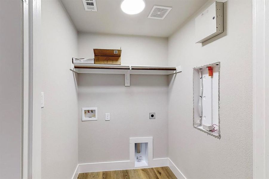 Laundry area with washer hookup, electric dryer hookup, and hardwood / wood-style flooring