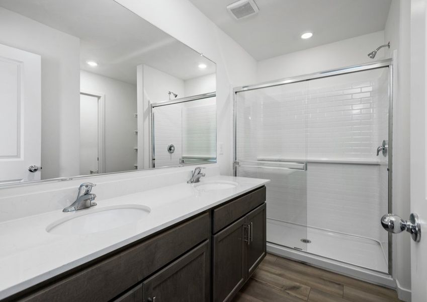 The master bathroom has a spacious walk-in shower.