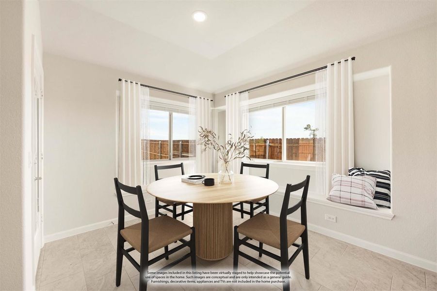 Dining area with round wood table, four black chairs, window seat, and large windows with white curtains
