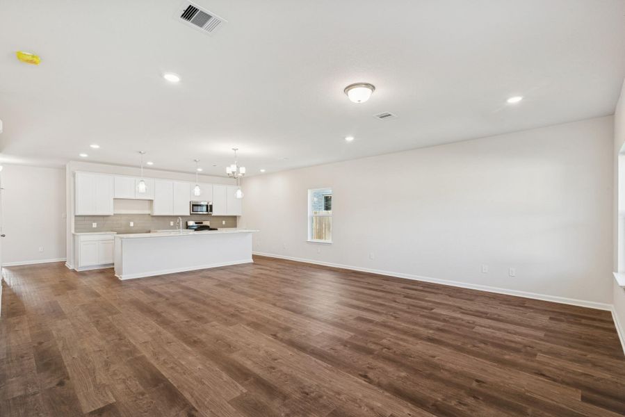 The Crawford- Family Room into Dining and Kitchen. Home under construction, photo used for illustrative purposes only, colors and options will vary.