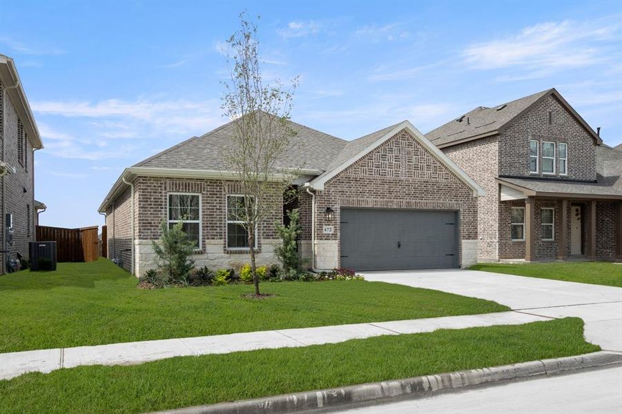 Front exterior of a new home in Wildflower Ranch, Justin, TX, highlighting curb appeal (Image 2). Front exterior of a new home in Wildflower Ranch, Justin, TX, highlighting curb appeal (Image 2).