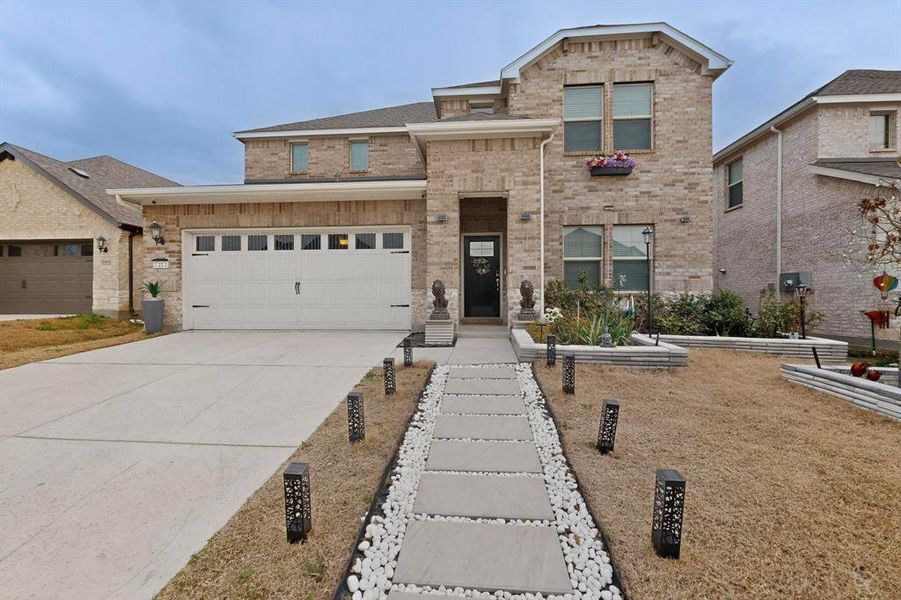 Front exterior of a new home in Wolf Creek Farms - Signature Series, Melissa, TX, highlighting curb appeal (Image 2).